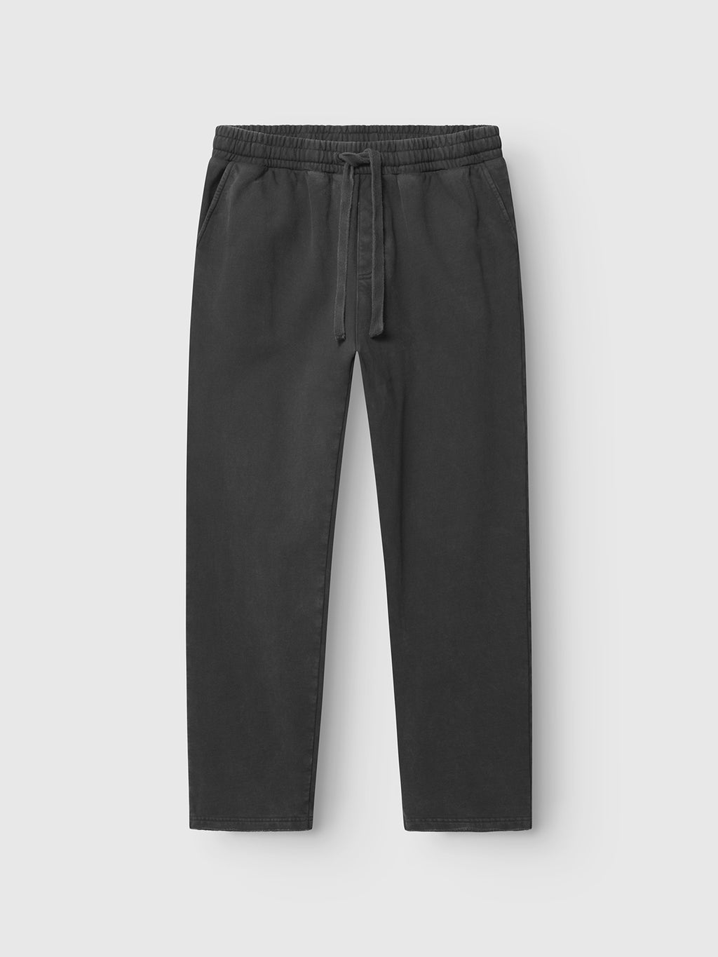 The Pireo Bump GWC - Black pants by Gabba are loose, straight-fit with an elastic waistband, drawstring, and side pockets, shown on a plain white background.