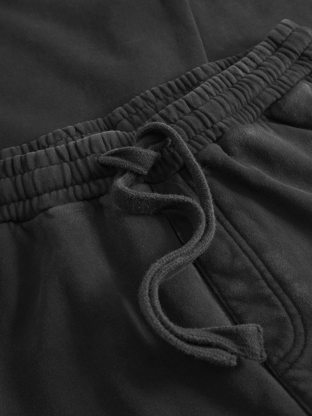 Close-up of Gabba Pireo Bump GWC - Black cotton jersey pants with an elastic waistband and drawstring, showcasing the textured fabric, detailed stitching, and comfortable loose straight-fit.