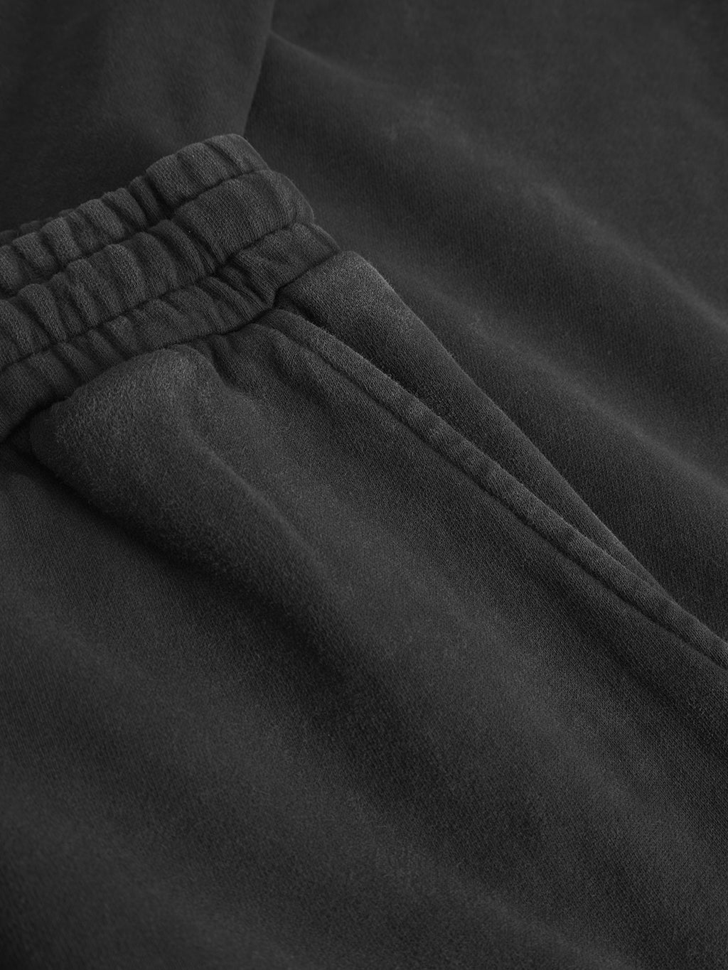 Close-up of Gabba’s Pireo Bump GWC - Black straight-fit pants, showcasing the elastic waistband, side pocket, and soft, subtly textured fabric.