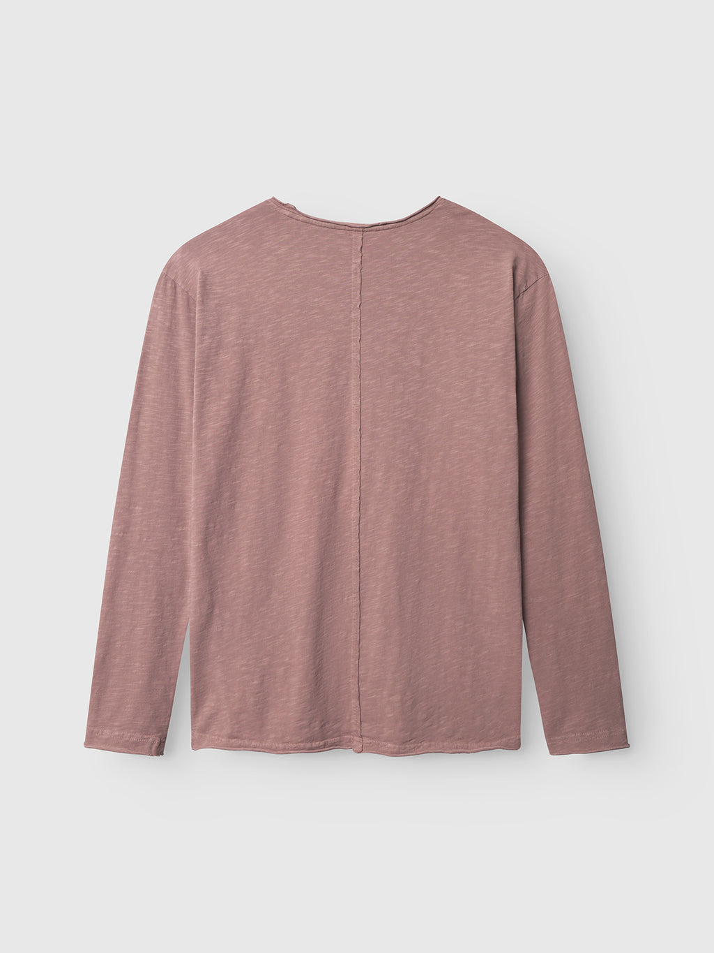 The Gabba Paros Rif GWC - Rose long sleeve t-shirt is shown laid flat with the back facing up, highlighting its center seam. Made from super soft cotton, it features a straight hem and a minimal, design-free look.