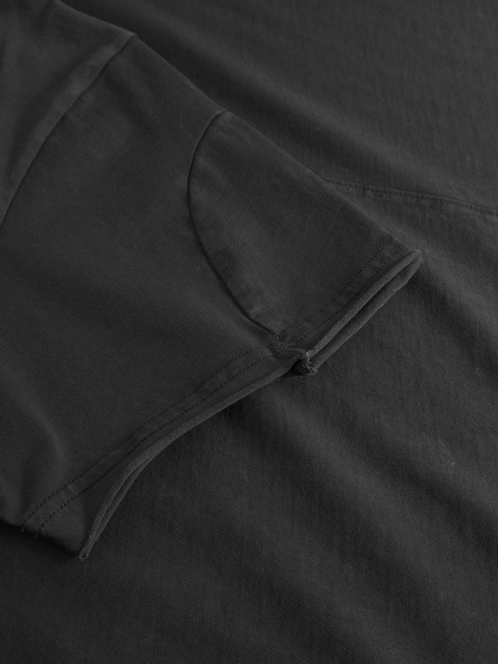 A close-up of the Gabba Idra Rig GWC - Black regular fit t-shirt laid flat, showcasing its folded sleeve and ultra-soft cotton fabric texture.