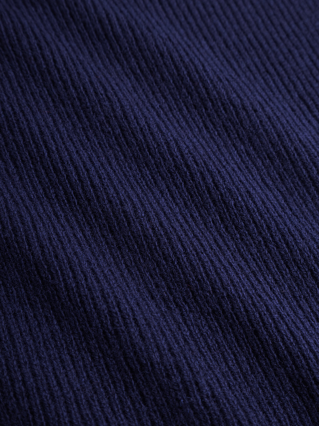 Close-up of the Gabba Biwa Aico - Navy scarf, featuring a soft, slightly fuzzy ribbed knit with a textured vertical striped pattern and evenly spaced ridges.