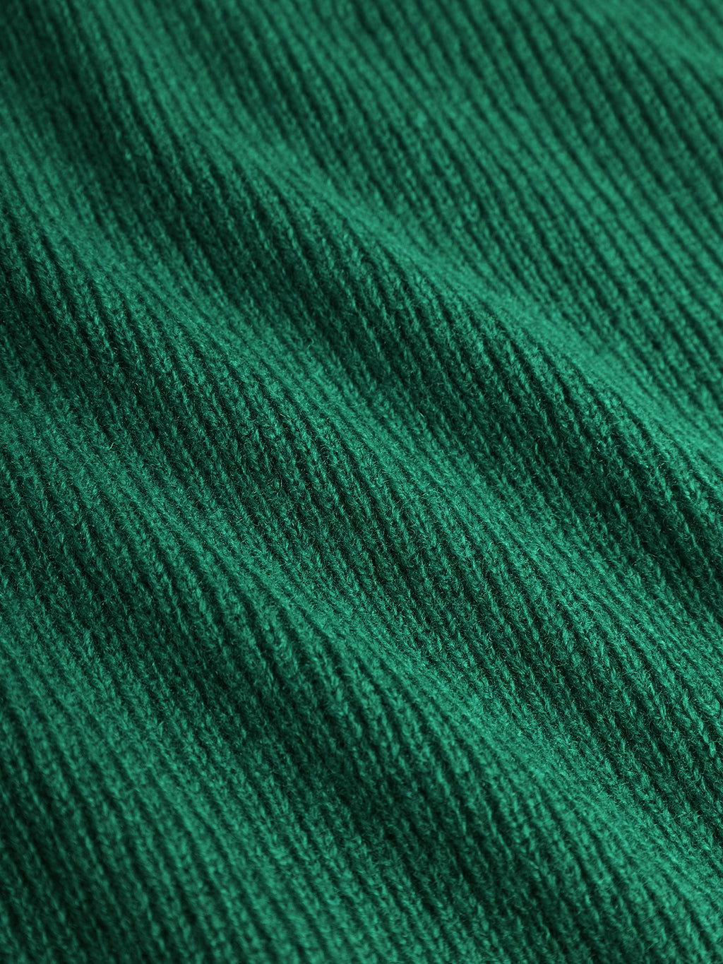 Close-up of the Gabba Biwa Aico - Green scarf, featuring ribbed, textured lines running diagonally across its wool surface.