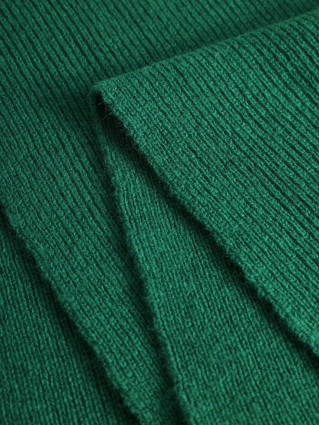 Close-up of Biwa Aico - Green scarf by Gabba, highlighting its ribbed knit texture and soft, slightly fuzzy surface.