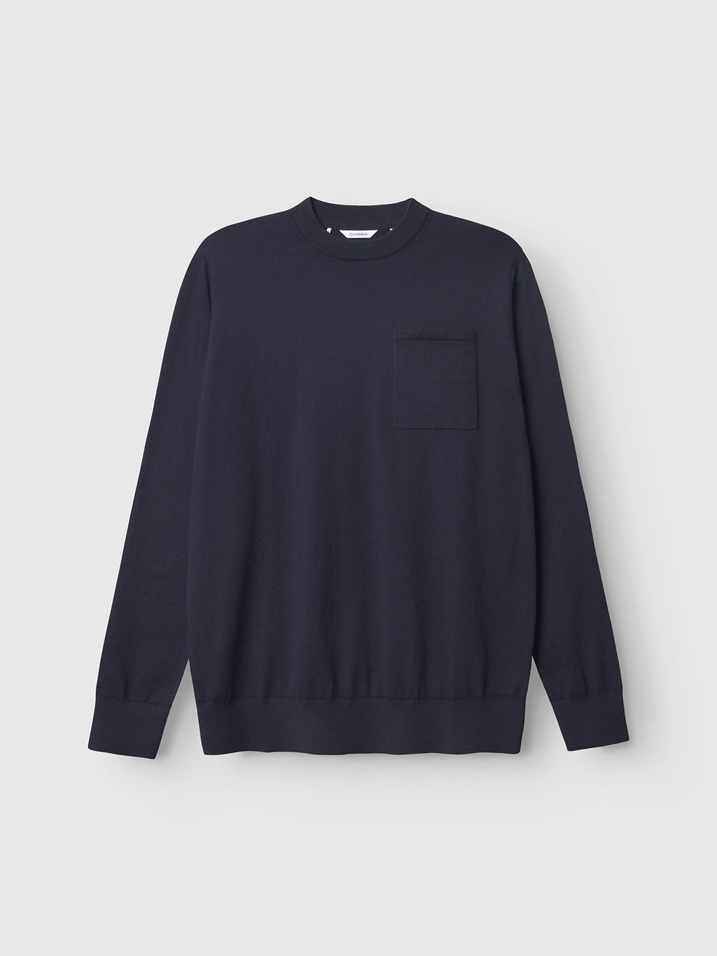 The Gabba Amori Prex LS - Navy is a mens regular fit, long-sleeved crew neck sweater with a small left chest pocket, shown against a light gray background.