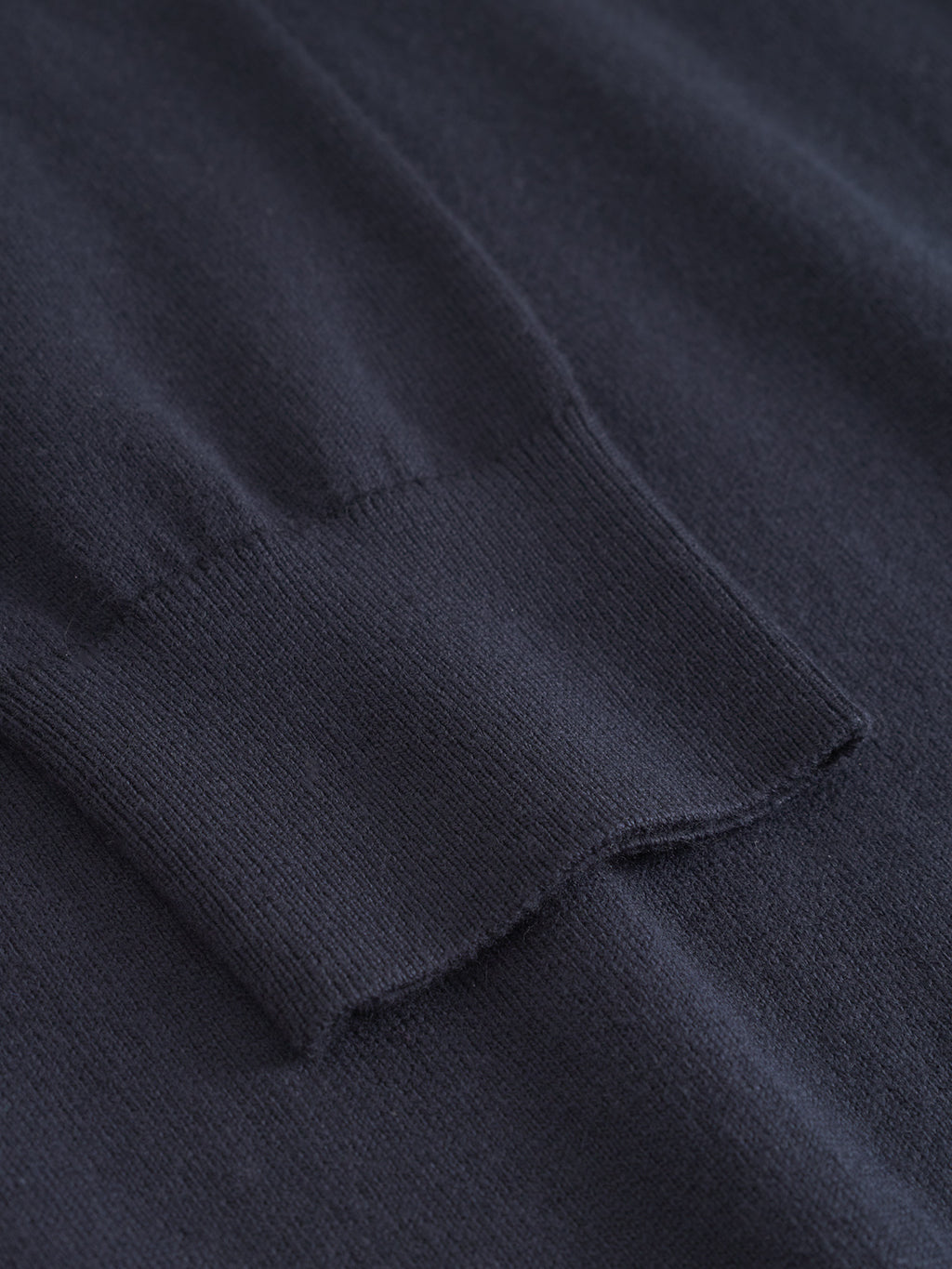 Close-up of the Gabba Amori Prex LS in navy, showing the ribbed cuff and smooth texture of this mens regular fit crew neck sweater laid flat.