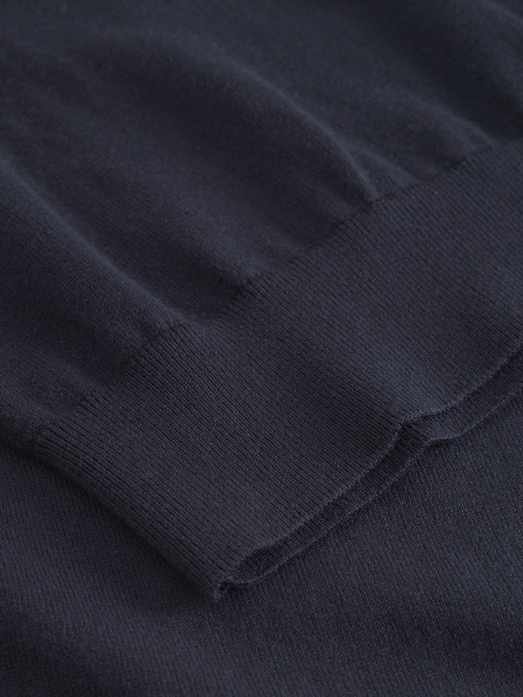 Close-up of the Gabba Amori Prex LS in navy, featuring a ribbed cuff and visible knit texture. The detailed stitching highlights its quality, making this crew neck sweater an ideal layering piece.
