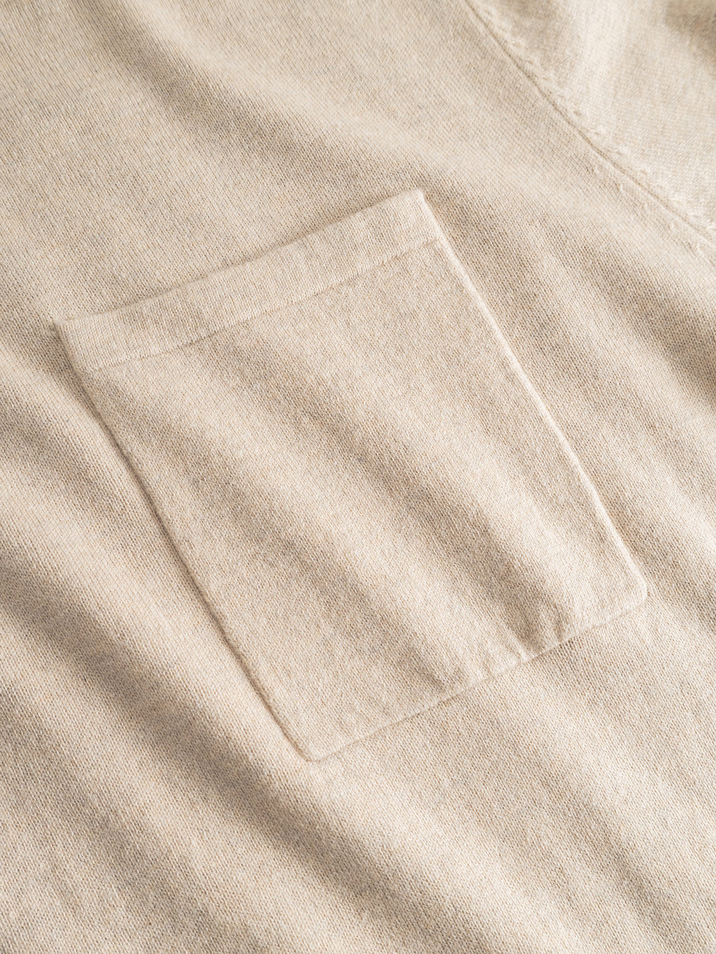 Close-up of the Gabba Amori Prex LS in Sand, showing a beige fabric shirt with a single rectangular chest pocket, textured details, and stitching, reminiscent of a regular fit sweater with ribbed cuffs.