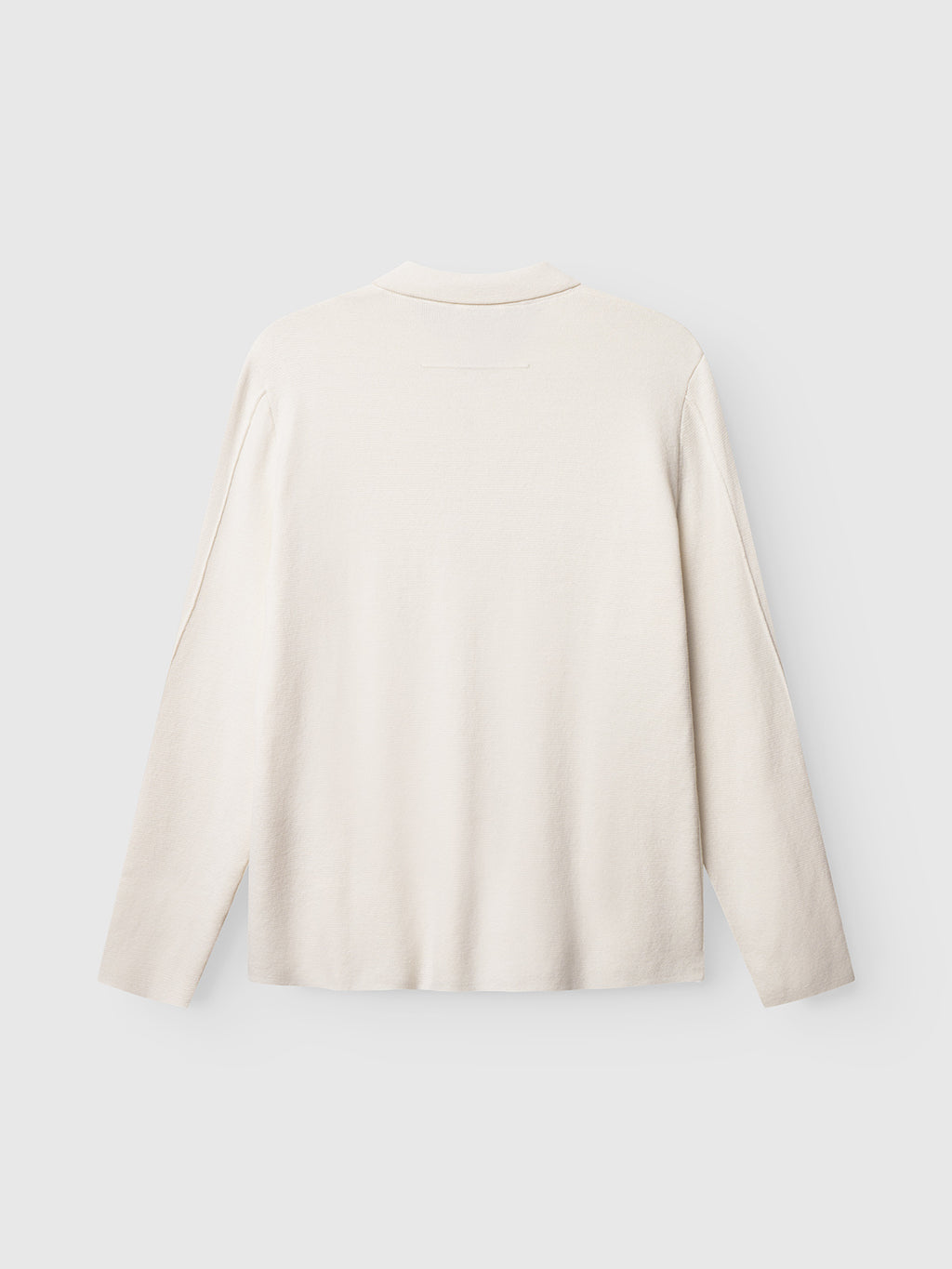 Back view of Gabba's Blanko New Cardi LS in off white, a minimalist long-sleeved sweater laid flat on a light gray background—ideal for layering or pairing with your favorite cardigan.