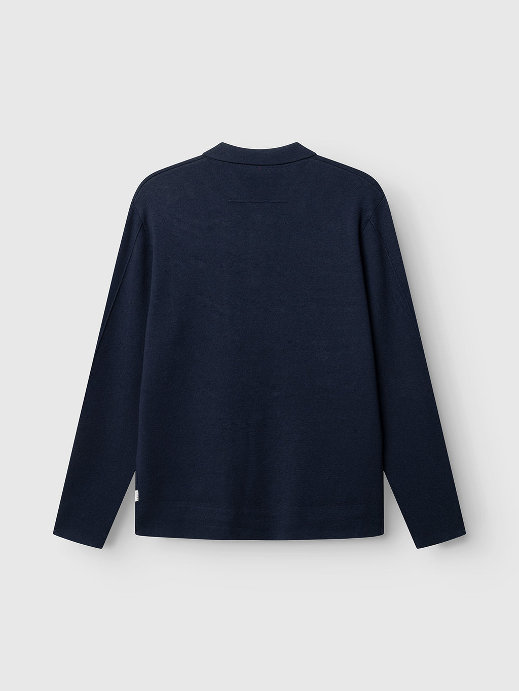 Navy blue long-sleeve shirt on a light gray background