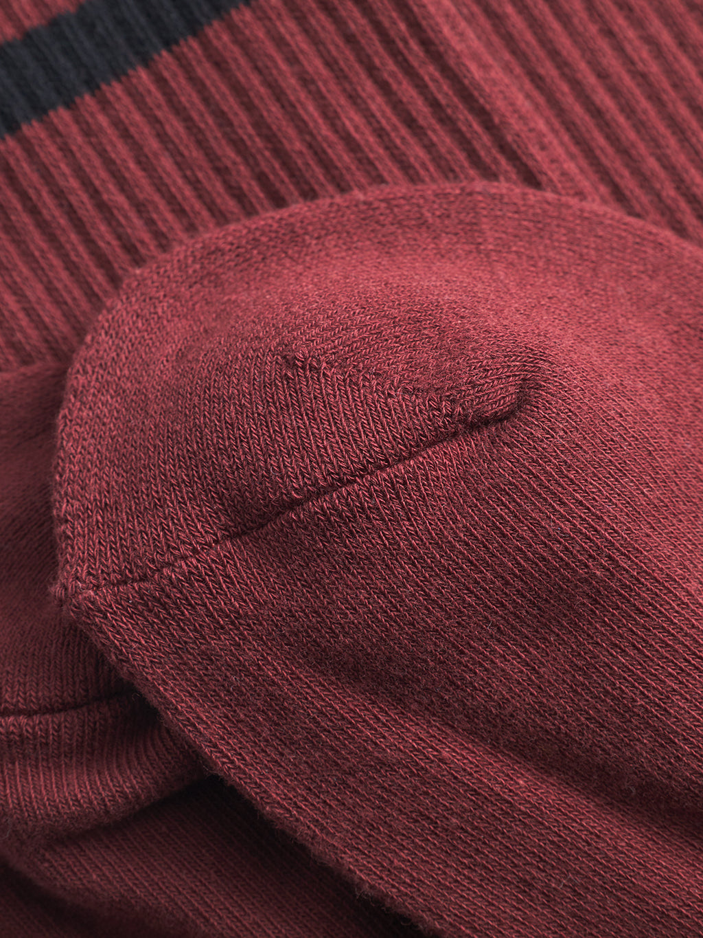 Close-up of the toe and heel of Gabba’s Zino Socks - Red Russet, featuring a black stripe, detailed knit texture, precise stitching, and premium comfort.