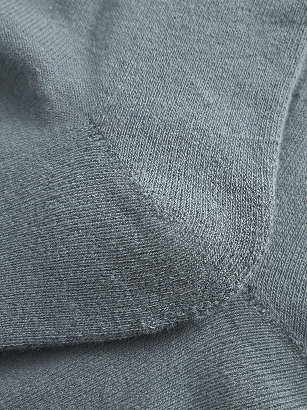 Close-up of the Dust Sage Green Zino Socks by Gabba, highlighting the intricate knitted texture and detailed stitching at seam intersections, similar to what’s seen in quality cotton blend socks.