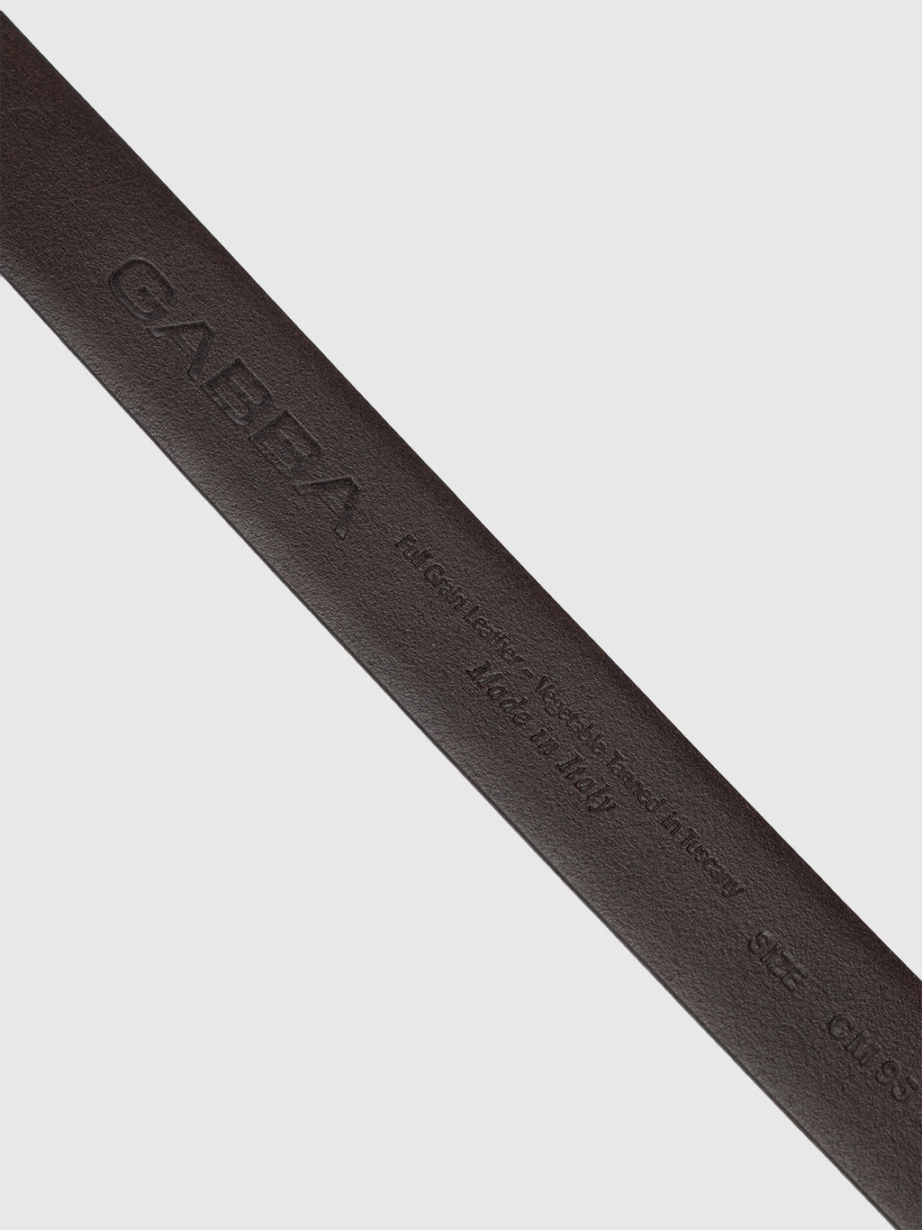 The Buk Belt - Brown by Gabba is a dark brown leather mens belt embossed with Gabba, Genuine Leather, Made in Italy, and size details—an elegant accessory photographed on a plain white background.