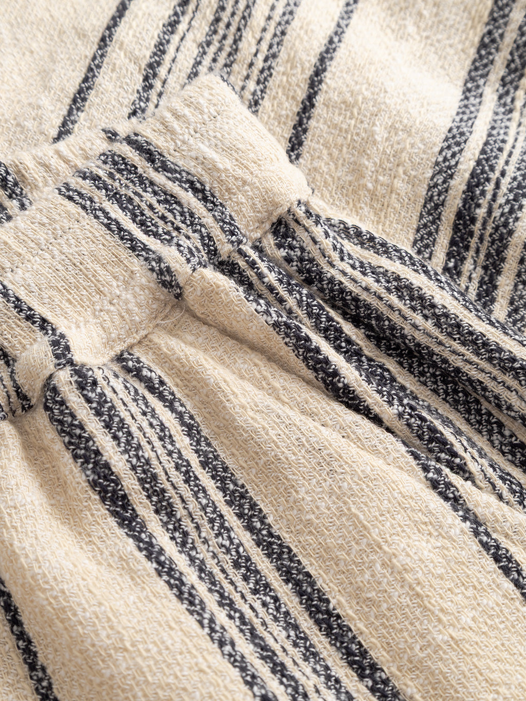Close-up of Gabba GABtommi Riga Shorts in navy with vertical stripes and an elasticated waistband. The fabric has a soft, slightly textured finish.