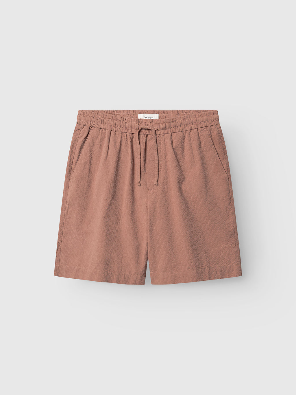 Gabba GABtommi Ker Shorts in Wood Pink feature a textured finish, elasticated waistband, drawstring, and two side pockets, shown against a plain light background.