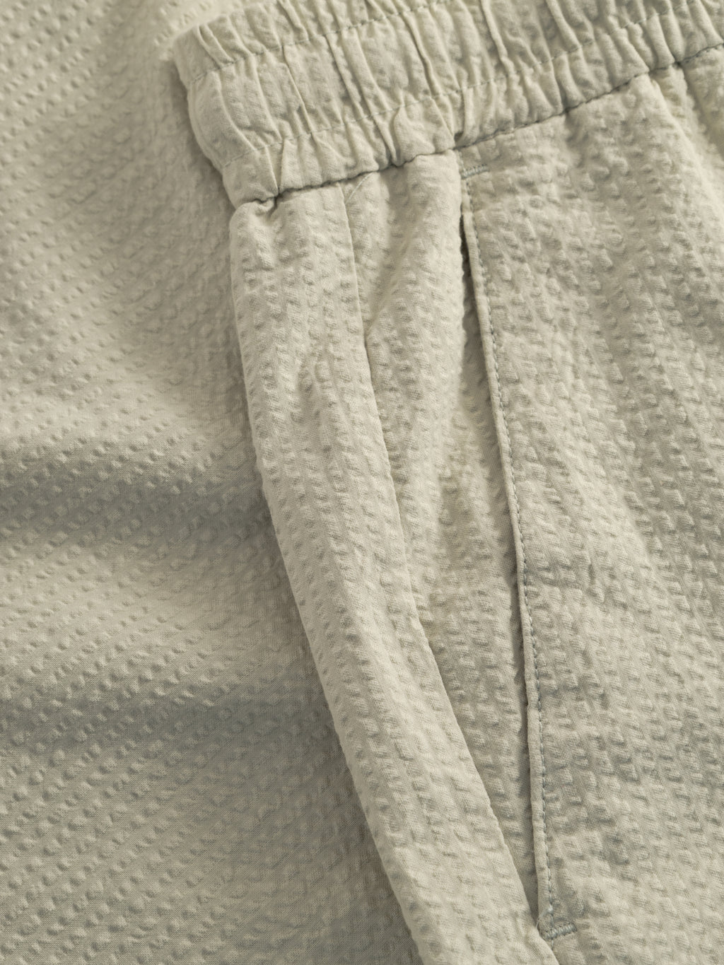 Close-up of Gabba GABtommi Ker Shorts in Alfa Green. Featuring textured fabric, an elasticated waistband, side pocket, and a subtle dotted pattern for a slightly bumpy look. Regular fit.