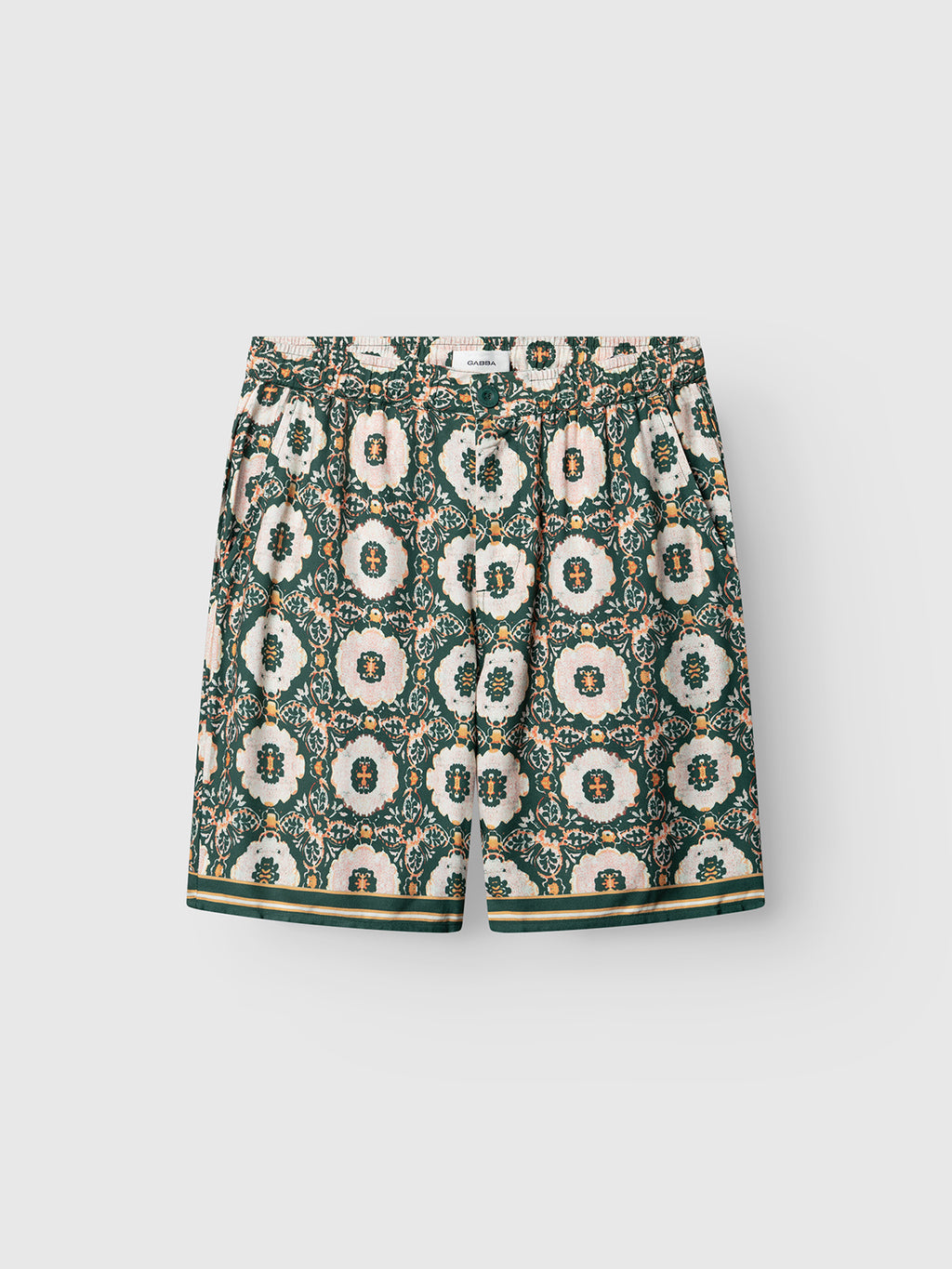 The Gabba GABtommi Oro Shorts - Green Pattern feature a green floral medallion print in cream, pink, and green, striped trim at the hem, and an elasticated waistband for comfort.
