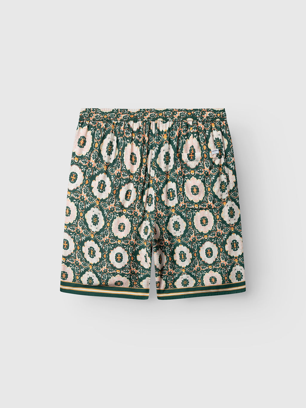 Gabba GABtommi Oro Shorts in a green pattern feature a white, pink, and green floral and circular print, elastic waistband, side pockets, and two green stripes at the hem. These floral print shorts are shown on a white background.