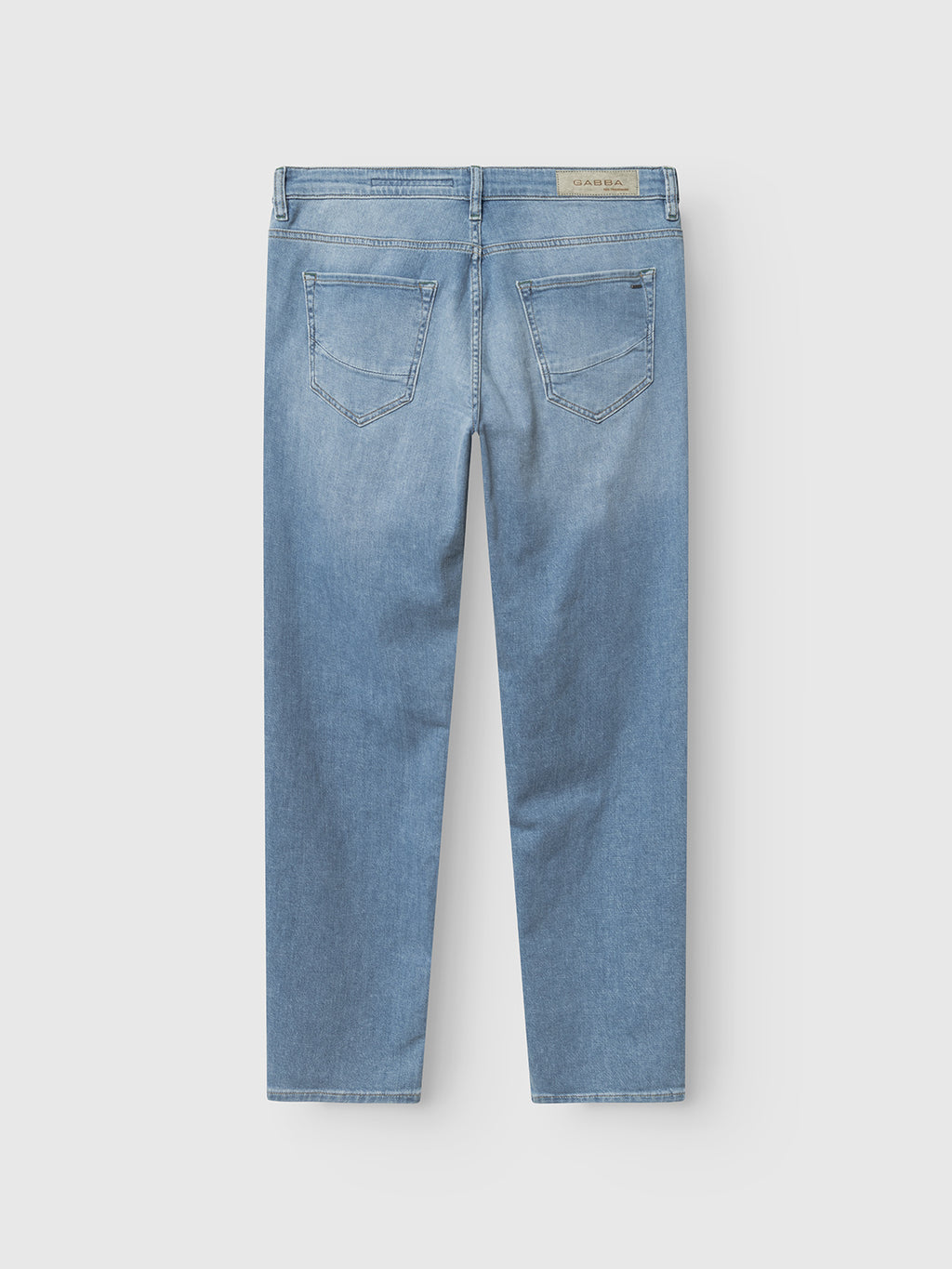 Gabba GABmarc Hobok Jeans in mid blue denim, shown from the back with two rear pockets, belt loops, and a beige waistband label. Made from regenerative cotton, these straight-cut jeans are laid flat on a white background.