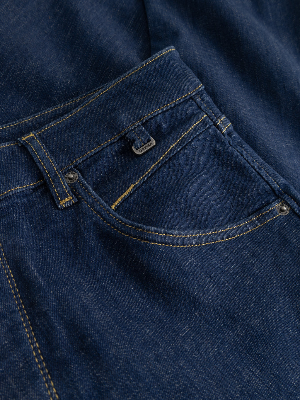Close-up of the front pocket on Gabba GABalex SX Cropped Jeans in dark denim, featuring detailed yellow stitching and a small coin pocket above the main pocket.