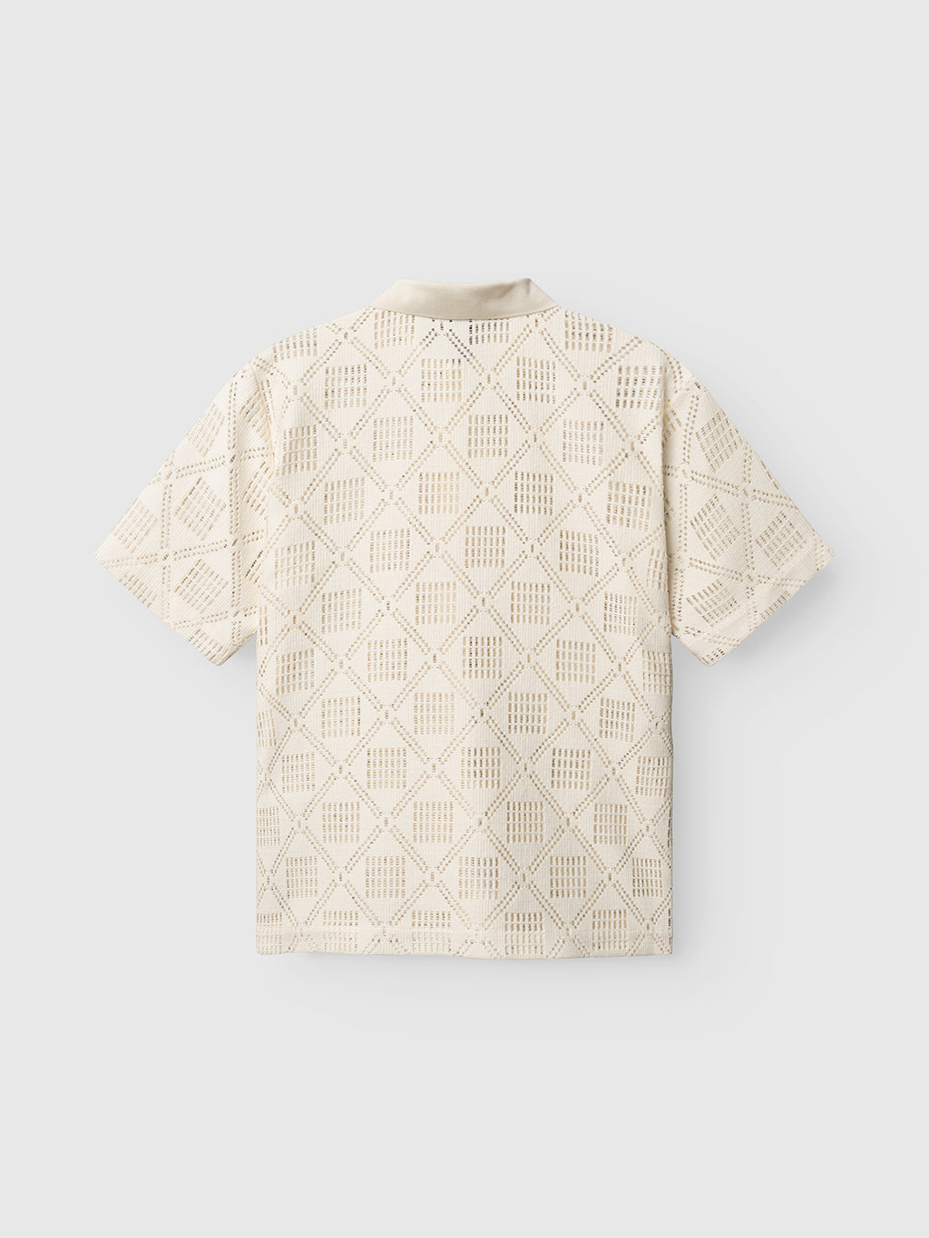The Gabba GABsteven Croch SS Shirt GRS in Birch is a short-sleeved, cream-colored shirt featuring an all-over geometric cutout pattern, shown from the back against a plain light background.