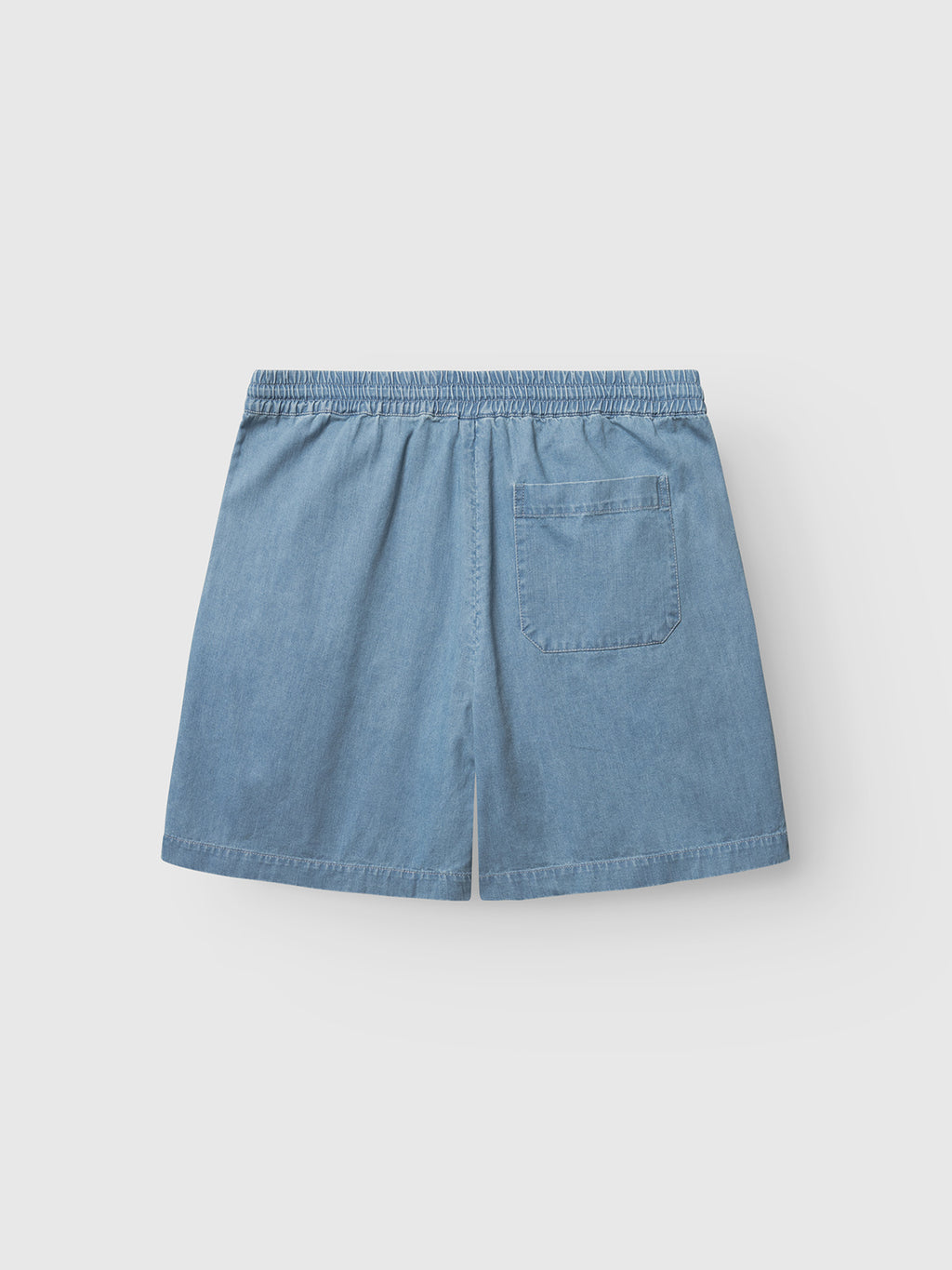 The Gabba GABtommi Denim Shorts in light denim blue feature a regular fit, elastic waistband, and a single back patch pocket, shown on a flat light gray background.