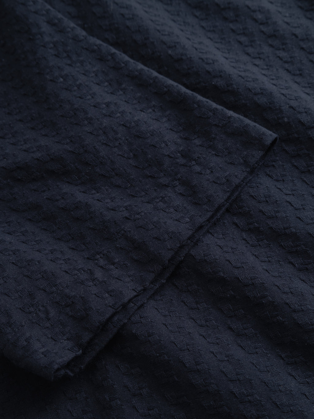 Close-up of the Gabba GABtimo Resort Neal SS Shirt in navy, showcasing its dark navy blue textured fabric with a subtle geometric pattern and a visible diagonal seam.