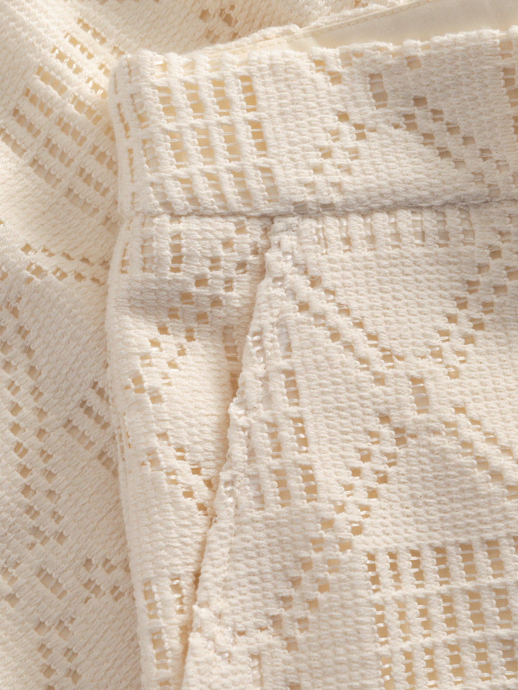 Close-up of Gabba's GABjoli Ted Croch Shorts GRS in Birch, featuring cream-colored textured crochet with a geometric diamond openwork pattern and raised woven structure—ideal for relaxed fits or breezy summer shorts.