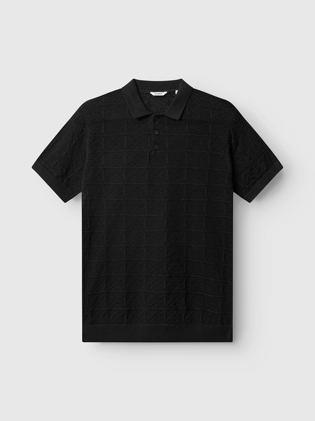 The Gabba GABbenson Fiwi SS - Black is a black short-sleeve knit polo featuring a subtle checkered texture, buttoned placket, and classic collar, shown against a plain light gray background.