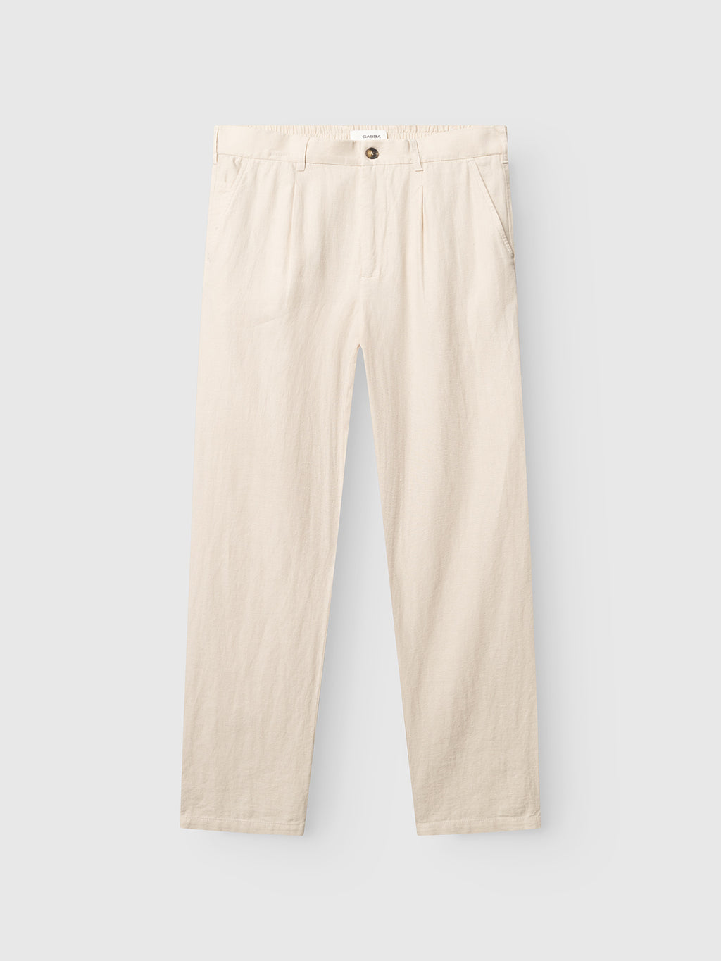 The GABnapoli 19 Lino Pant - Birch by Gabba features a beige straight-leg design with side pockets, an elastic waistband, button closure, and zip fly, displayed laid flat on a light gray background.