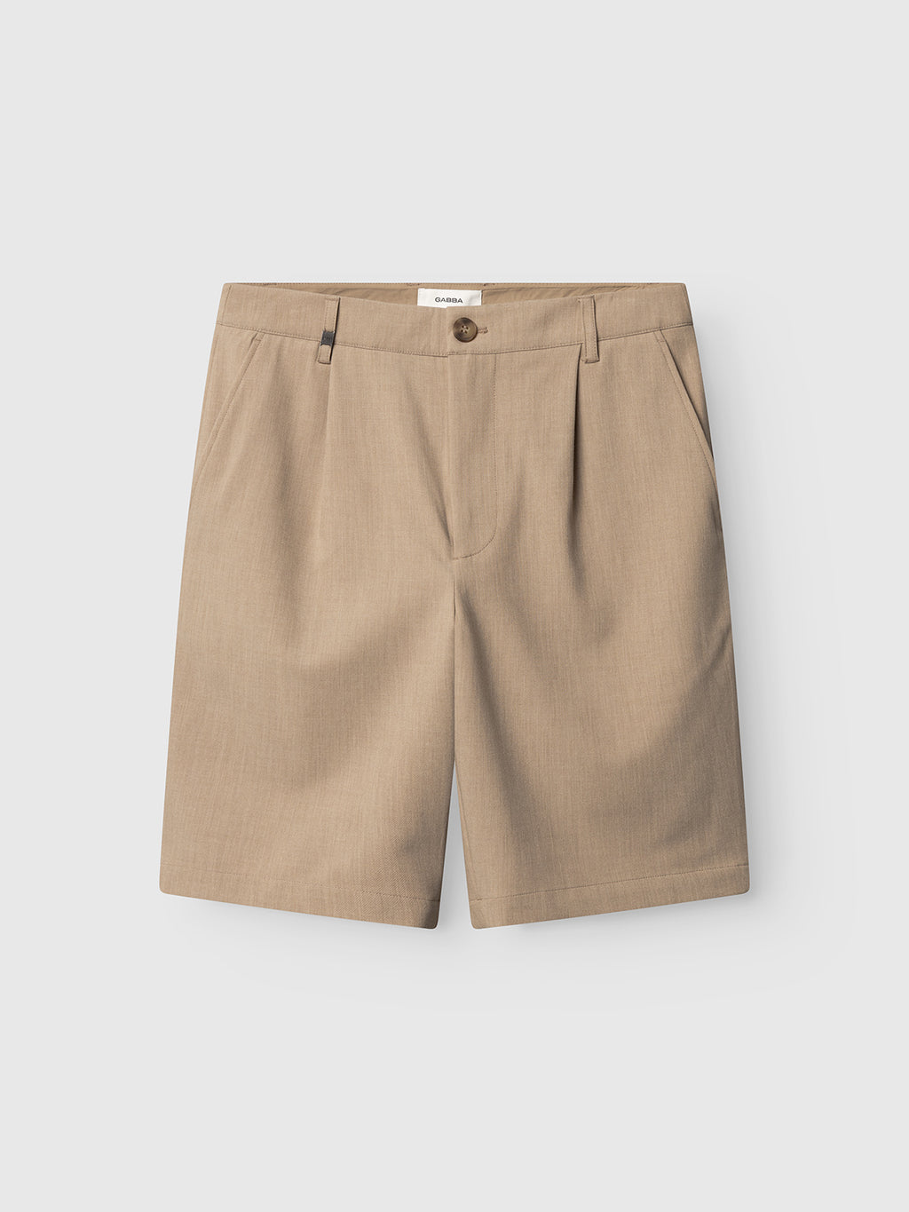 Flat-lay image of Gabba GABjoli Pas Phin Shorts GRS in Sand Plaza, a beige, knee-length chino style with belt loops, front button, and side pockets, displayed on a plain light gray background.