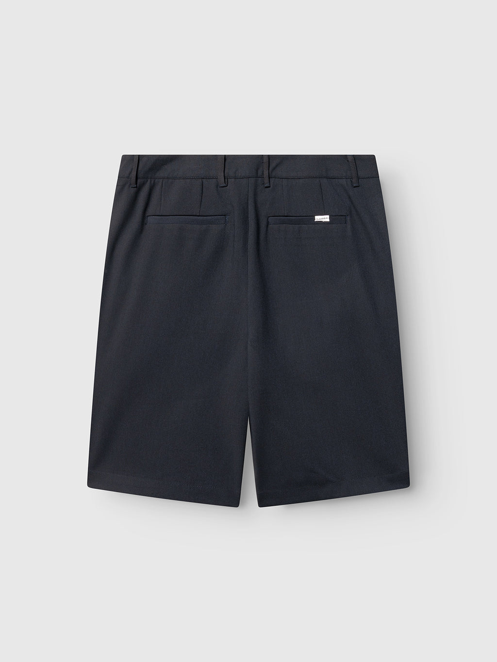 Gabba GABjoli Pas Phin Shorts GRS in blue black, shown from the back with two welt pockets, belt loops, and a small white tag above the right pocket, displayed on a light gray background for a tailored look.