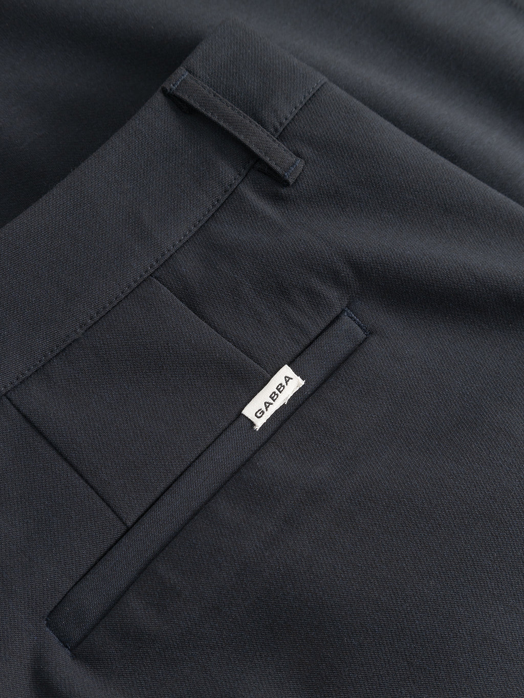 Close-up of the Gabba GABjoli Pas Phin Shorts GRS in Blue Black, featuring a back pocket with a subtle white Gabba tag. The smooth, slightly textured fabric and tailored look add refinement to this versatile piece.