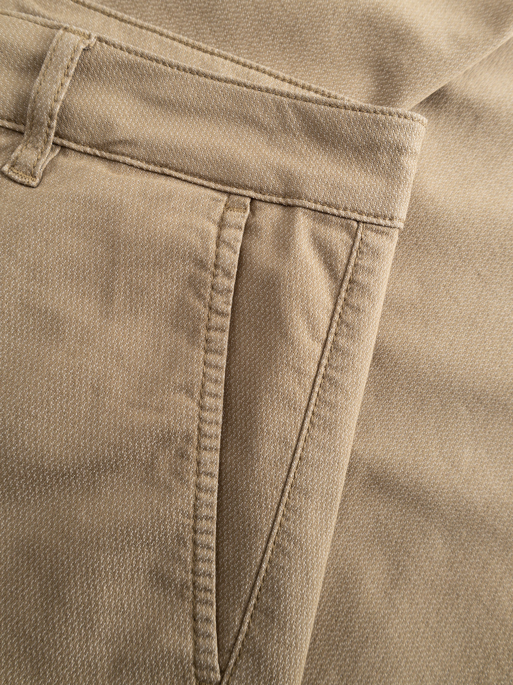 Close-up of the Gabba GABjoe Nopleats Dale Pant in Sand, showcasing its waistband, belt loop, and side pocket with visible stitching. Made from a high-stretch cotton-blend for comfort and a modern tapered-fit silhouette.