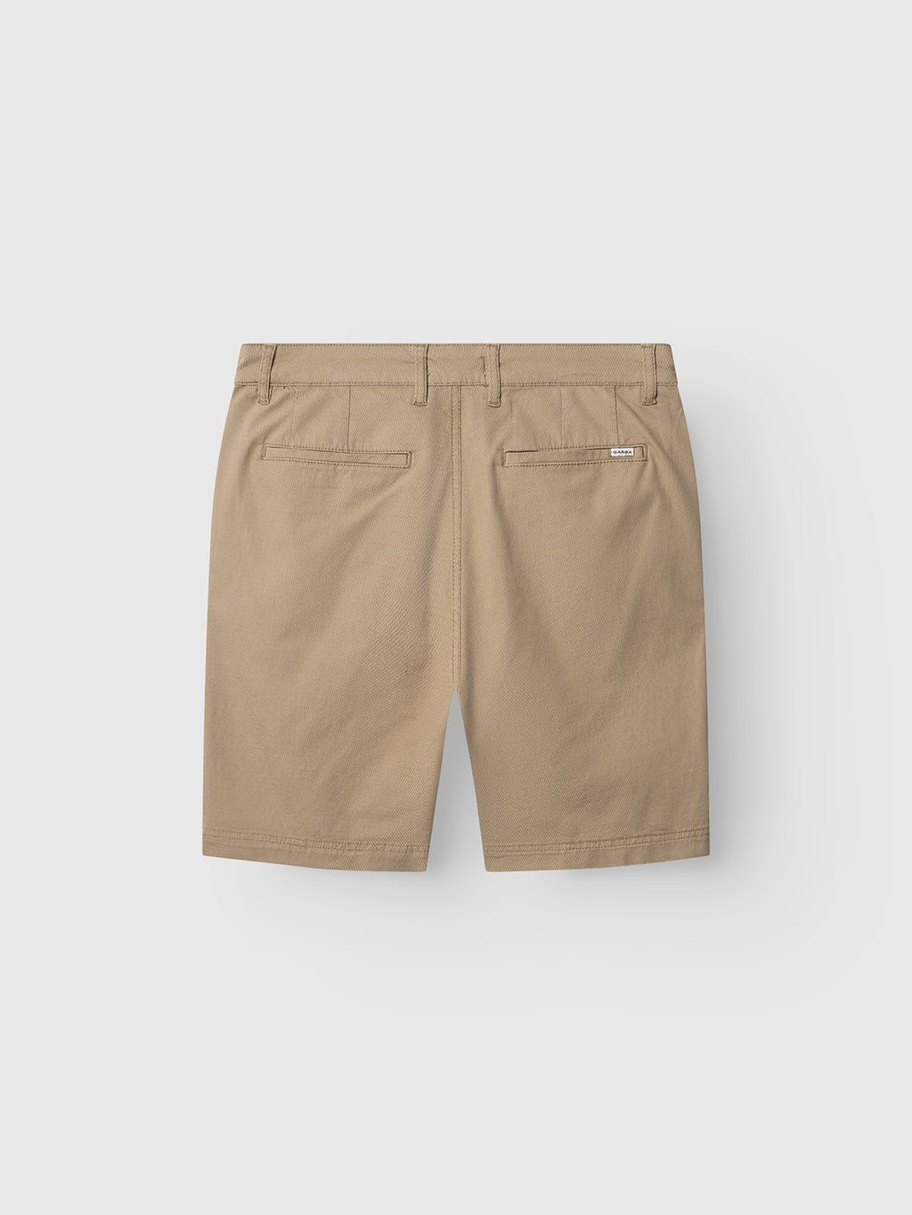Back view of Gabba GABjoli Nopleats Dale Shorts in Sand, featuring belt loops, two back welt pockets, and a small stitched brand label above the right pocket, displayed on a plain light gray background.