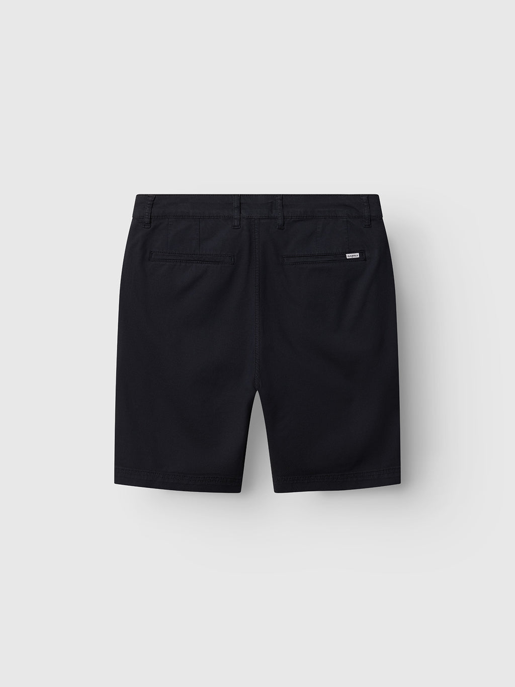 The Gabba GABjoli Nopleats Dale Shorts in Blue Black are shown from the back with two pockets, belt loops, and a logo tag above the right pocket, set against a plain light gray background.