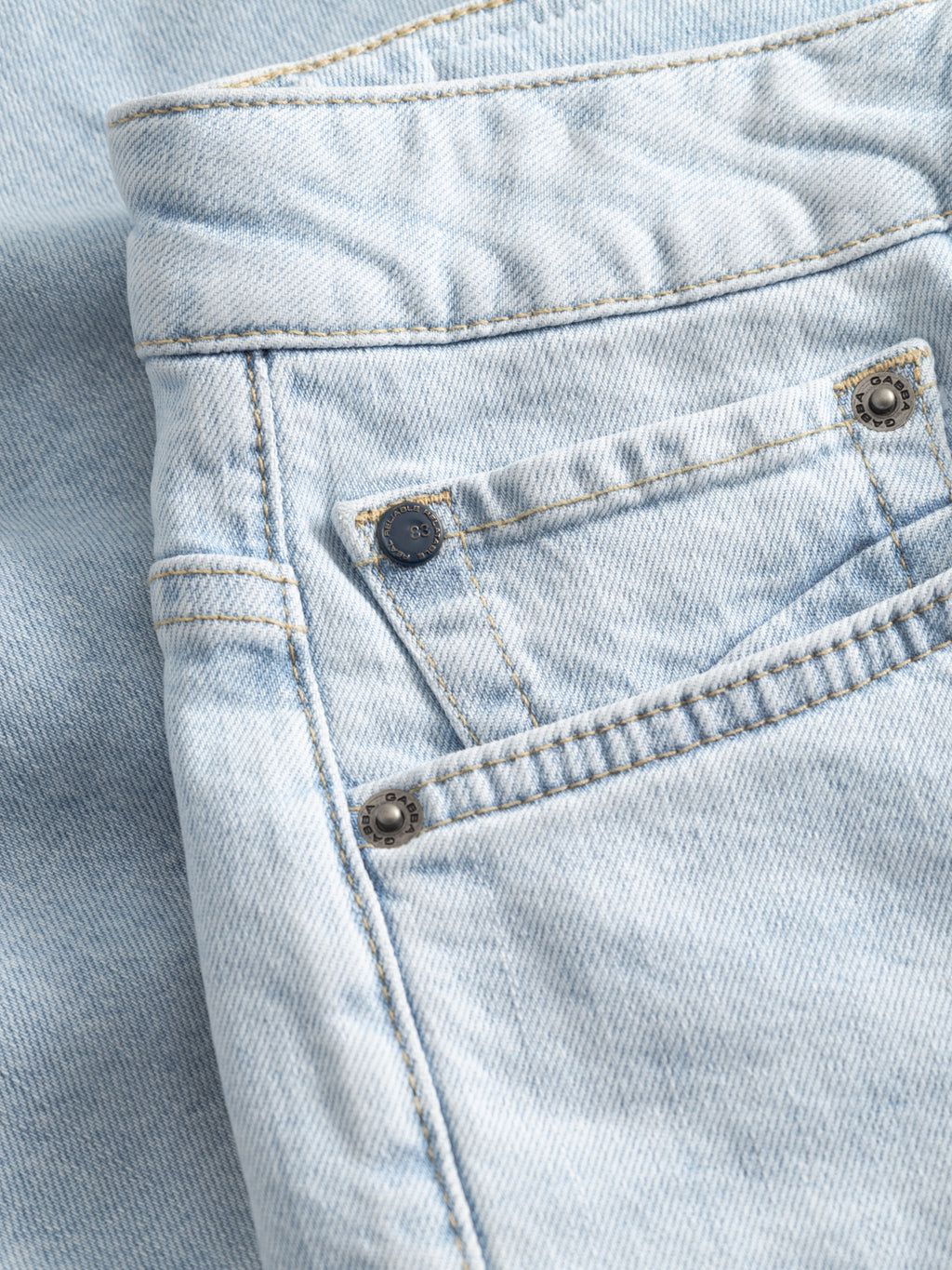 Close-up of the back pocket on Gabba GABmarkus Derby Shorts in light blue denim, highlighting comfort-stretch fabric, stitching, a rivet, and subtle fading—ideal for casual summer style. The shorts are laid flat with focus on the pocket area.