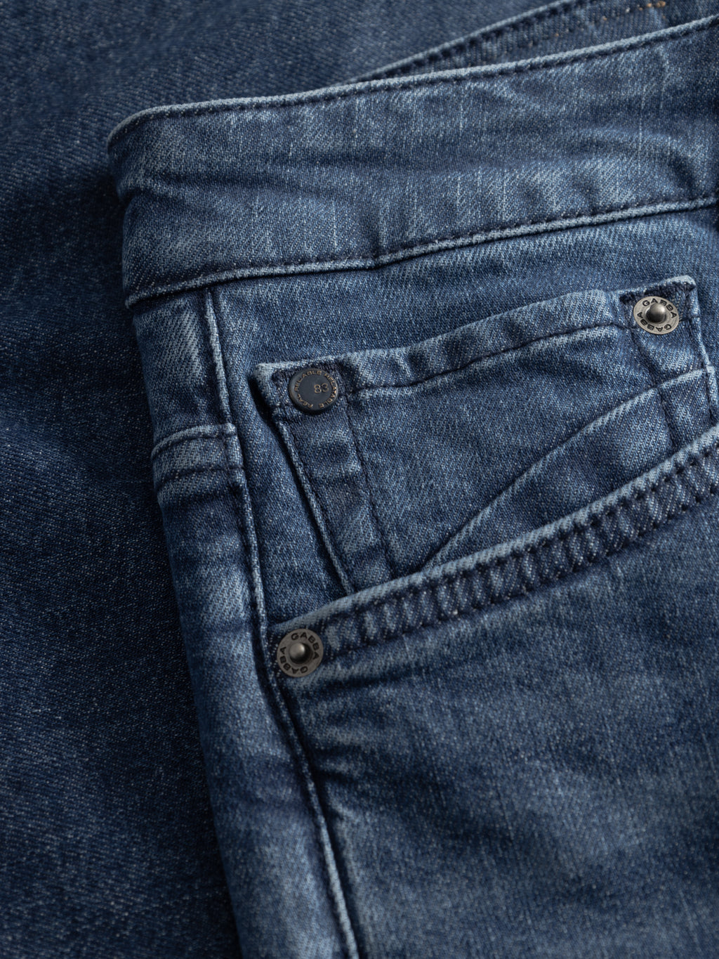 Close-up of Gabba GABmarkus Derby Shorts in denim wash, showing the front pocket, coin pocket, and metal rivets, highlighting the comfort-stretch fabric’s texture and stitching.