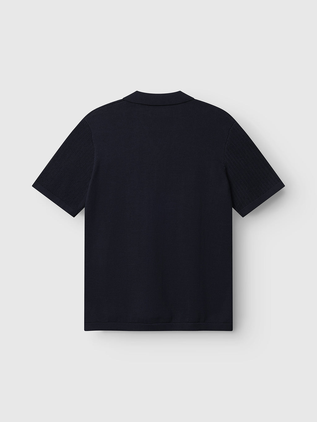 The GABgeno Resort Bride SS Knit - Navy by Gabba is displayed from the back against a light gray background, featuring short sleeves and a simple, logo-free design.