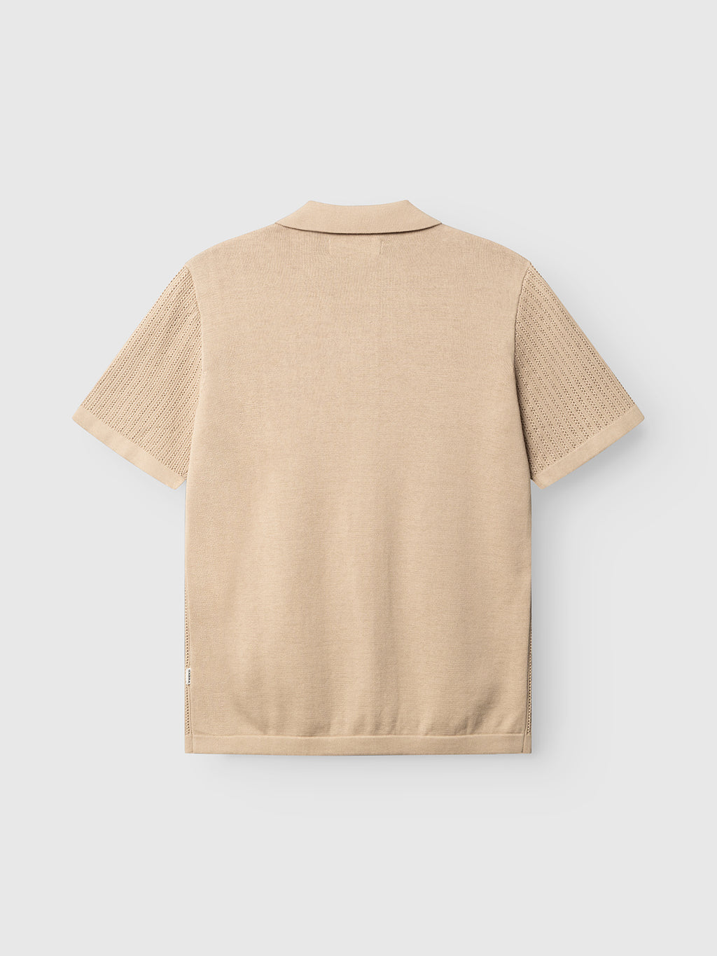 The Gabba GABgeno Resort Bride SS Knit in Sand, shown from the back with a flat collar and textured knit sleeves, is displayed against a plain light gray background.