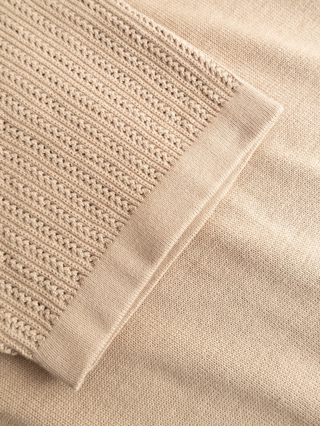 Close-up of the Gabba GABgeno Resort Bride SS Knit in Sand, highlighting the contrast between its ribbed knit pattern on one section and smooth knit fabric on another.