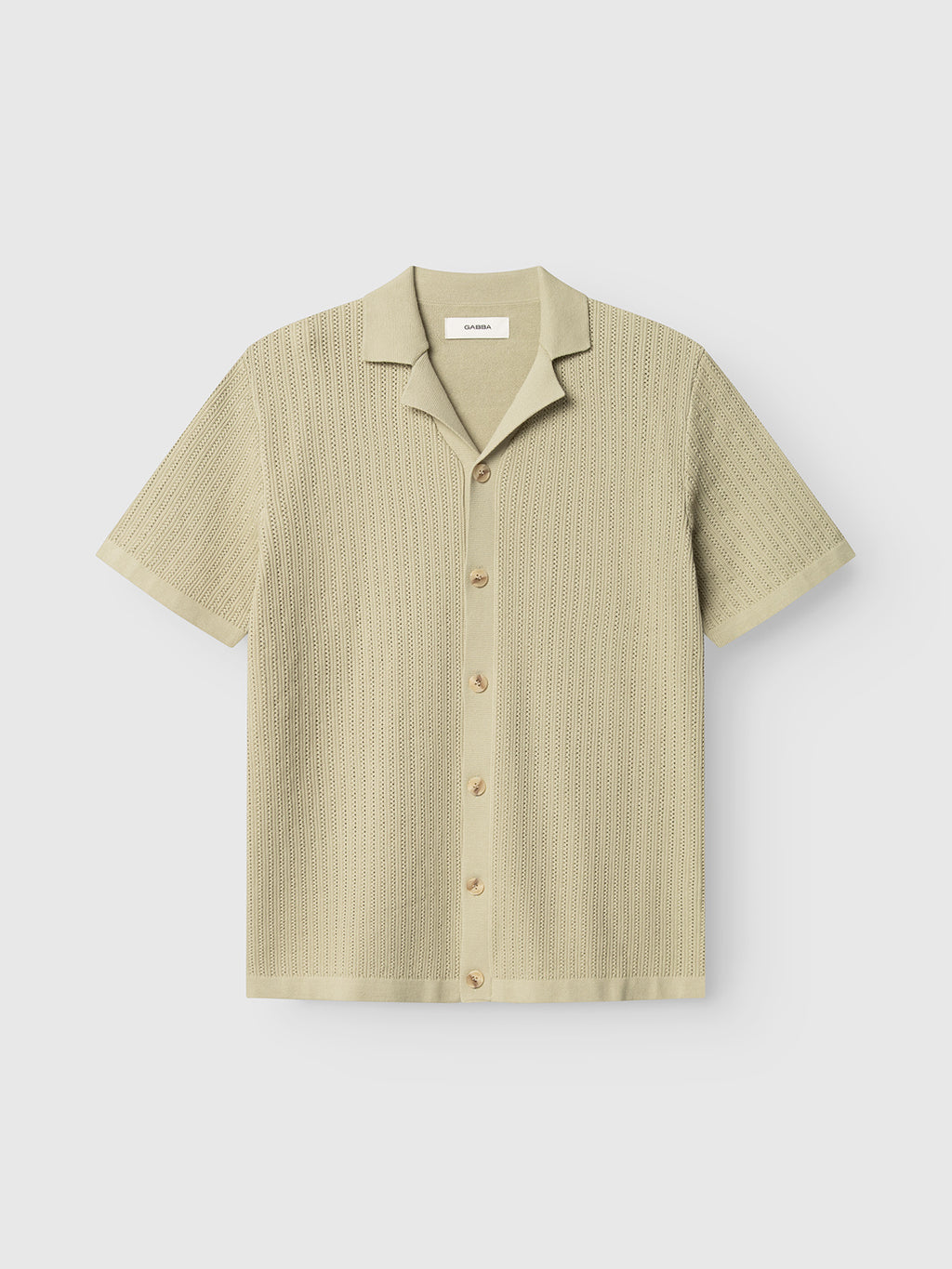 The Gabba GABgeno Resort Bride SS Knit in light green features short sleeves, a textured cotton knit, button-down front, and resort collar, showcased flat on a plain white background.