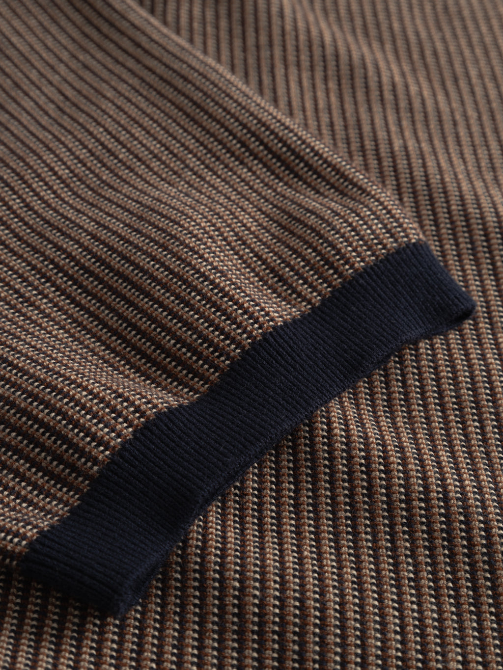Close-up of Gabba's GABoswald Retro SS Knit in navy, featuring ribbed knit fabric with a brown and beige striped pattern and a black ribbed cuff.