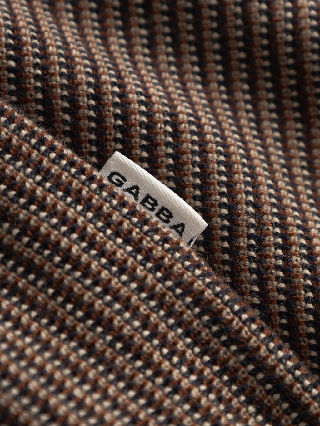 A close-up of navy striped fabric from the Gabba GABoswald Retro SS Knit, featuring a white 