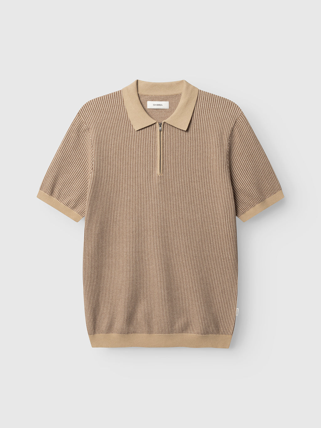The Gabba GABoswald Retro SS Knit in Walnut is a short-sleeve, ribbed polo shirt with tan collar, cuffs, and hem, a front zipper, and a relaxed fit.