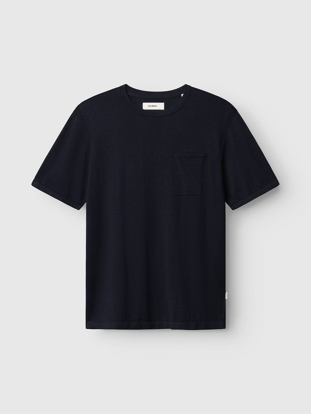 The Gabba GABvento Dush SS Knits in Navy is a lightweight flat knit t-shirt featuring a small left chest pocket, shown on a light gray background.