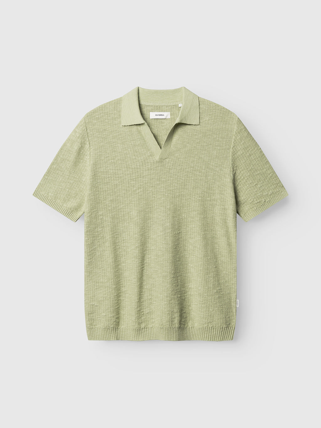 The Gabba GABcross Alto SS Knit in Alfa Green features short sleeves, a V-neck collar, ribbed hem, and cuffs. Displayed on a plain white background.