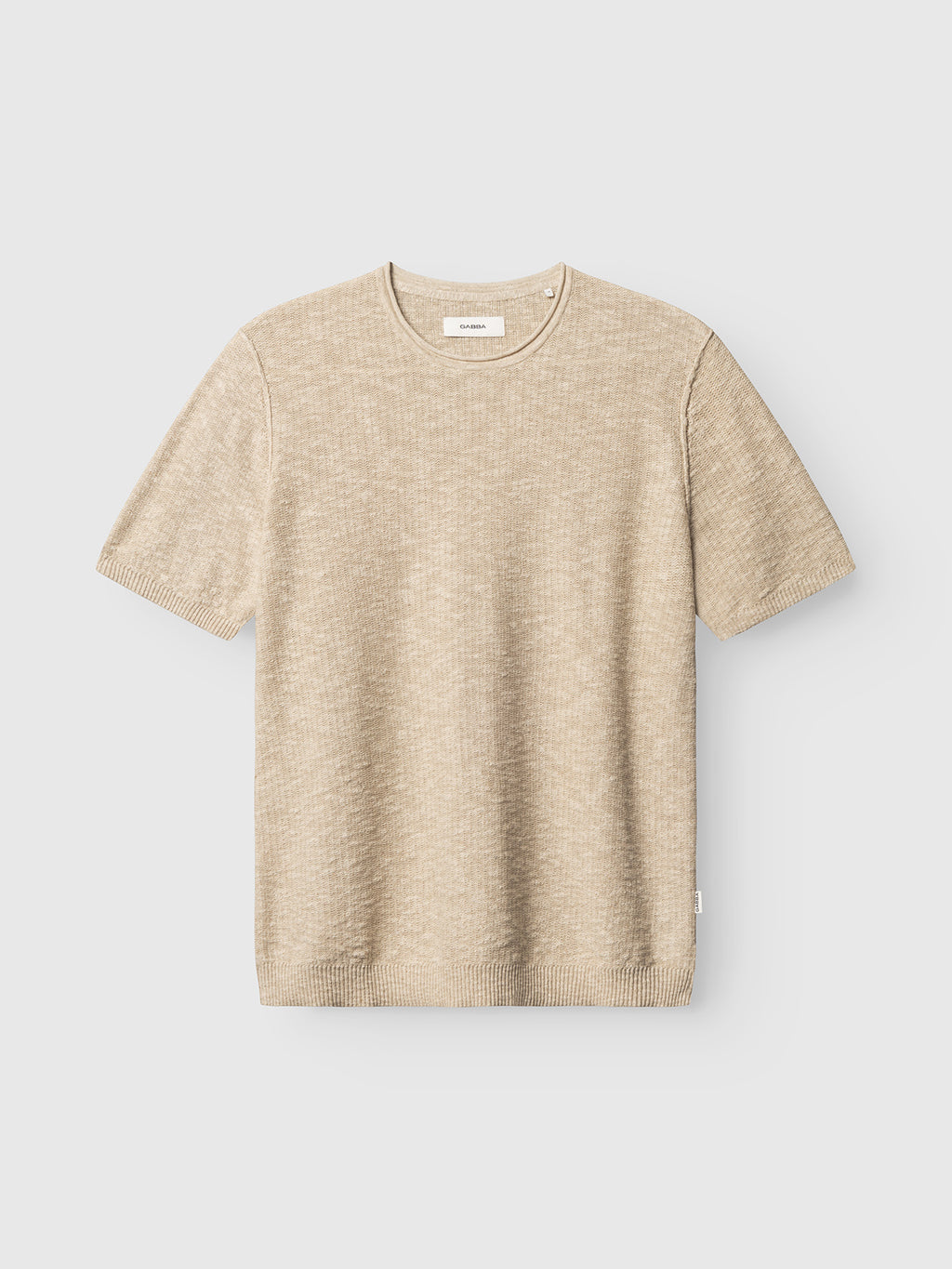 The Gabba GABnigel Alto SS Knit in Ecru is a casual, lightweight short-sleeve sweater with a crew neckline and subtle textured pattern, shown flat on a light grey background.