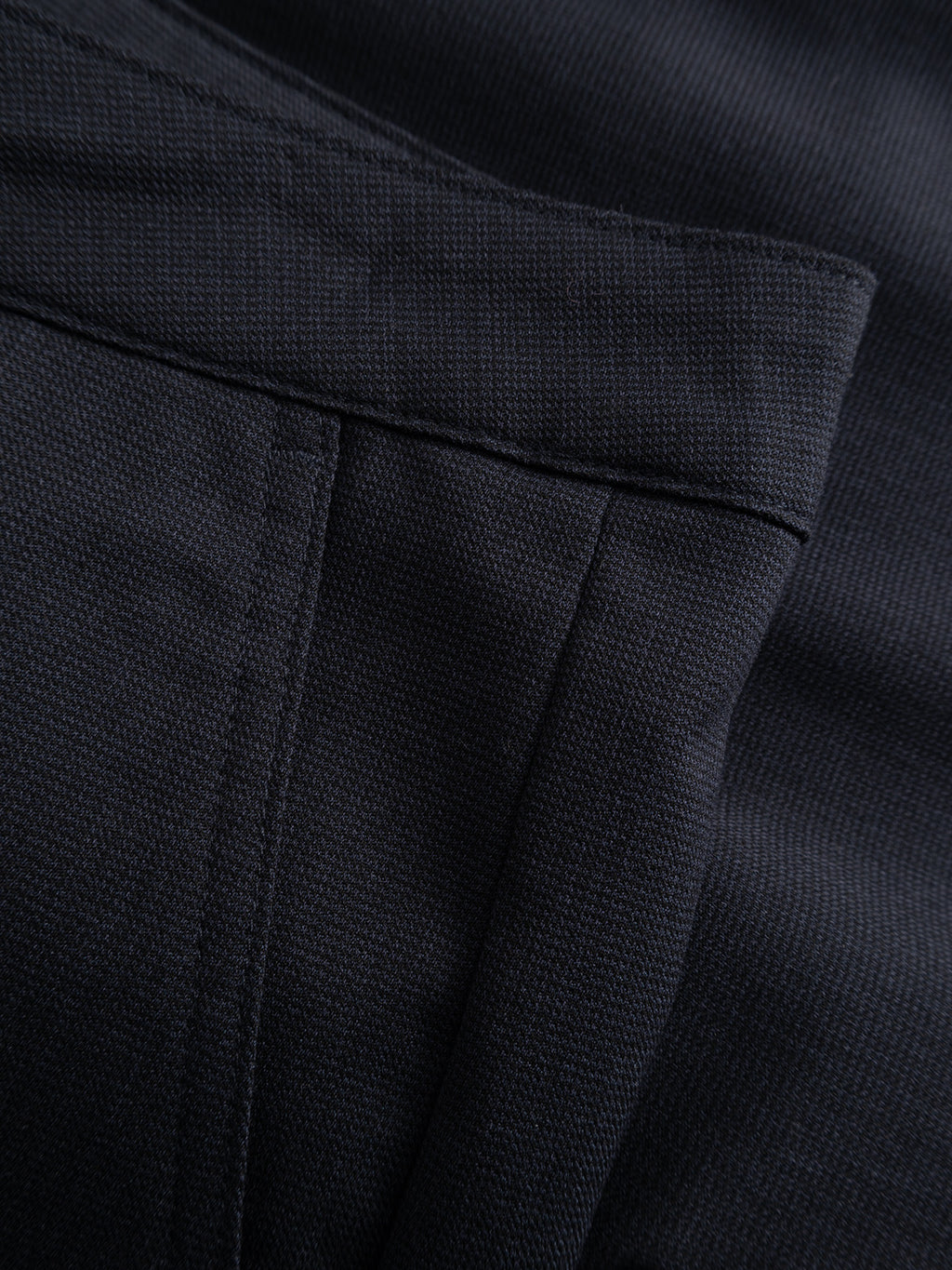 Close-up of the pocket and waistband on the Gabba GABjet Deme Shorts in Dark Navy, highlighting the fabric texture, stitching, and button closure that define their classic slim-fit silhouette.