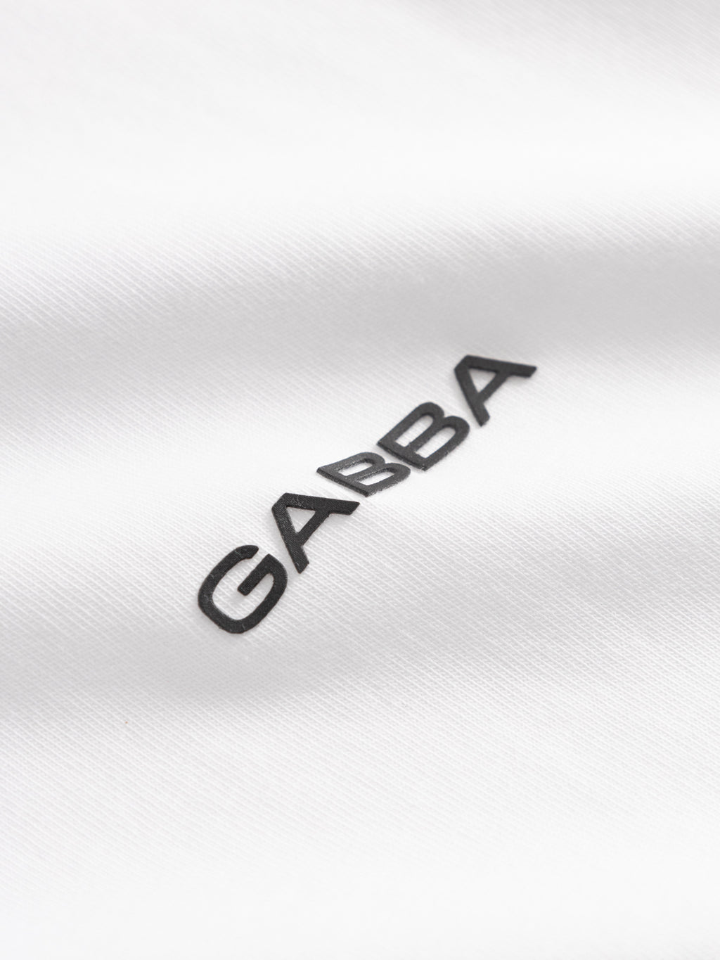 Close-up of the GABnigel Boxy Logo GOTS SS - White by Gabba, featuring 